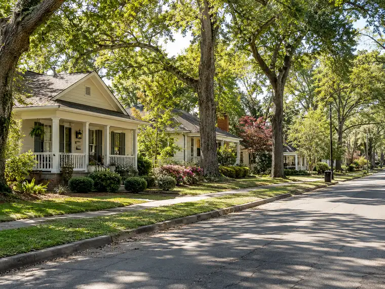 Illustrative scene: a quiet street of modest older homes in a Southern town.